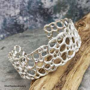 This is a picture of an open work silver bangle