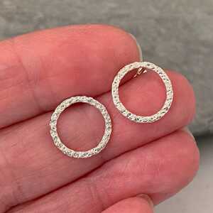 This is a picture of a pair of silver circle stud earrings