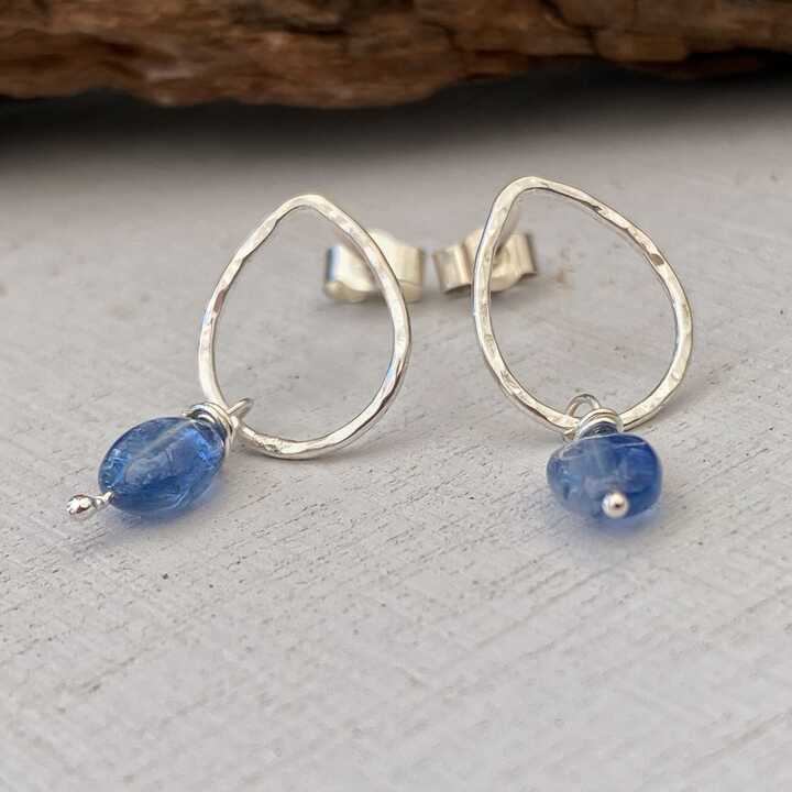 This is an image of a pair of hammered silver stud earrings with Kyanite drops 