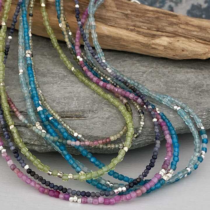 This is a picture of a selection of bright colour gemstone bead necklaces