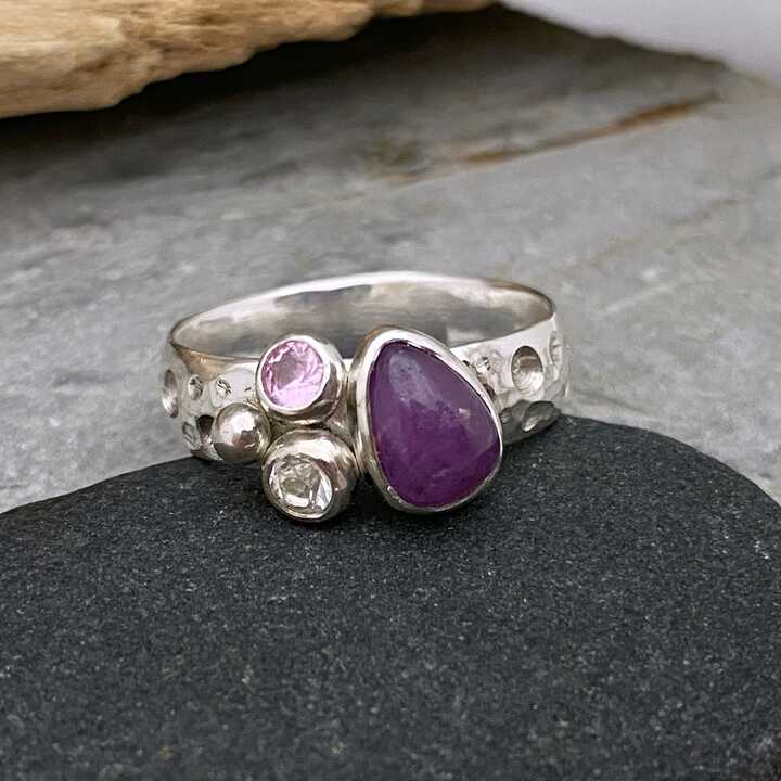 This is a picture of a silver and purple sapphire ring