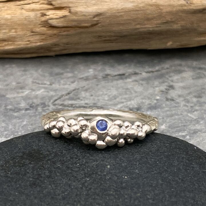 Silver bubbles ring set with a blue sapphire