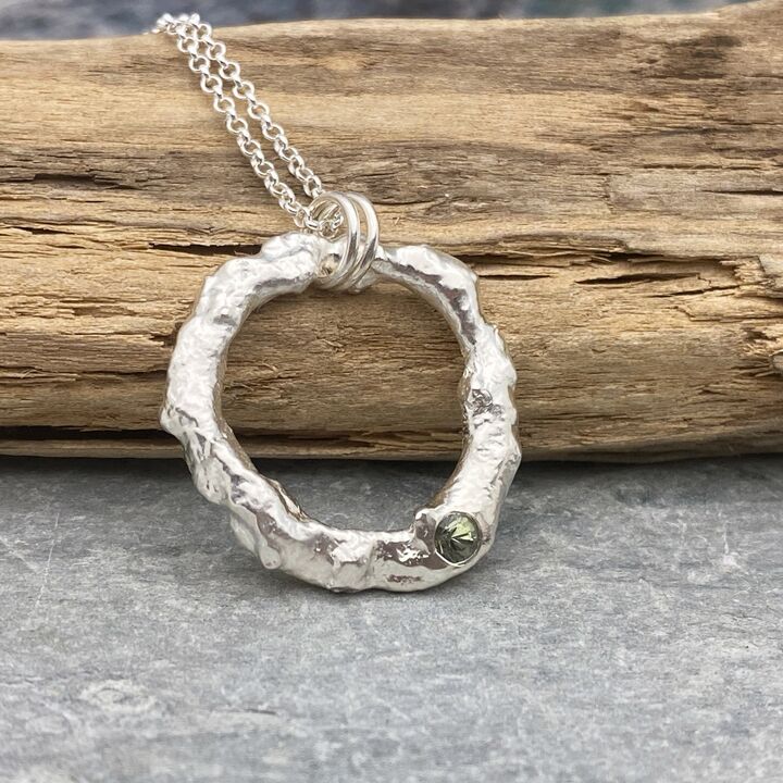 Organic silver circle pendant with a green sapphire  3