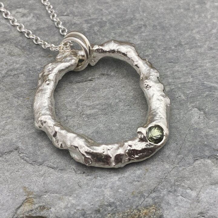 Organic silver circle pendant with a green sapphire  4