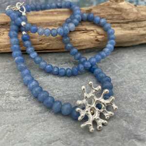 This is a picture of an organic silver pendant with an Aquamarine gemstone